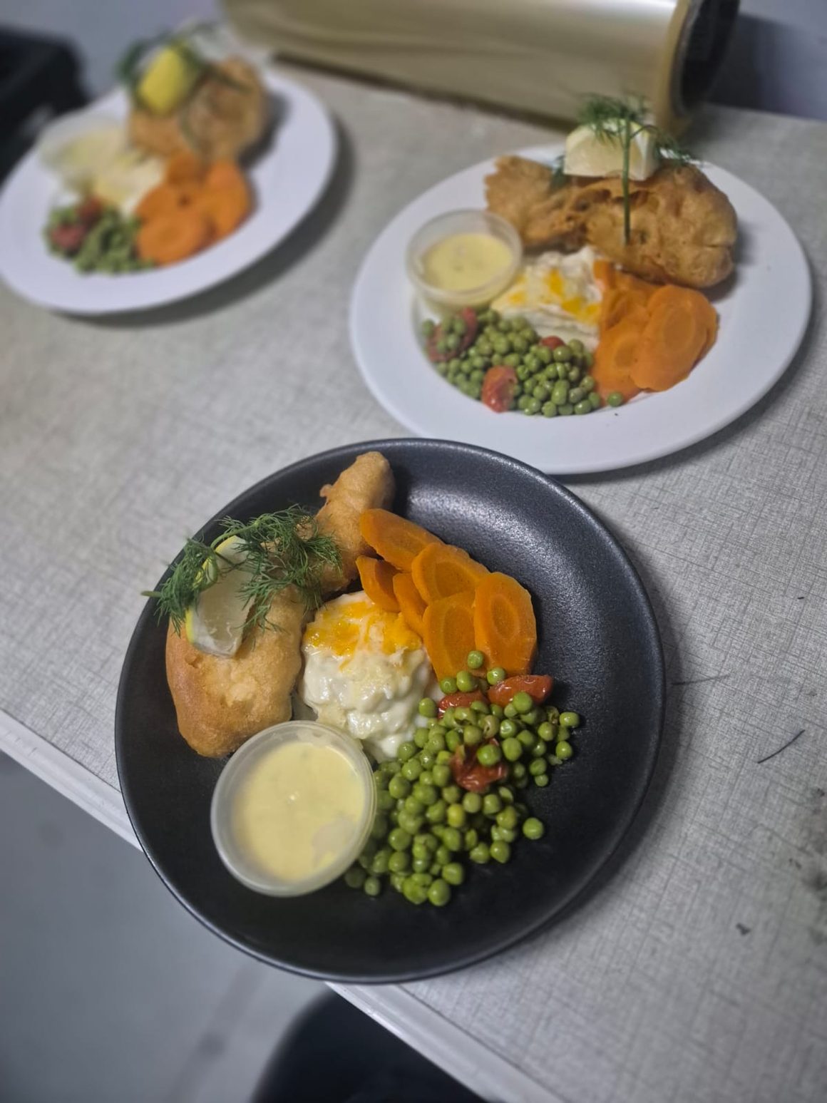 Plated mains ready for service at an event by King Protea Services