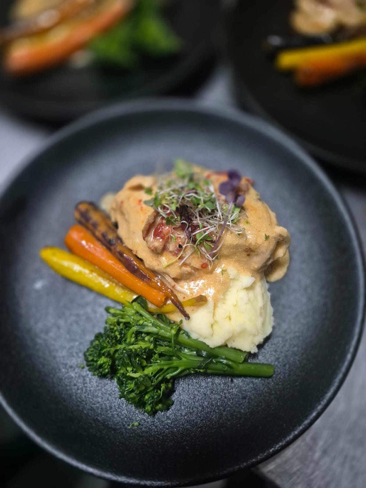 Chef-plated chicken with baby carrots and broccolini by King Protea Services
